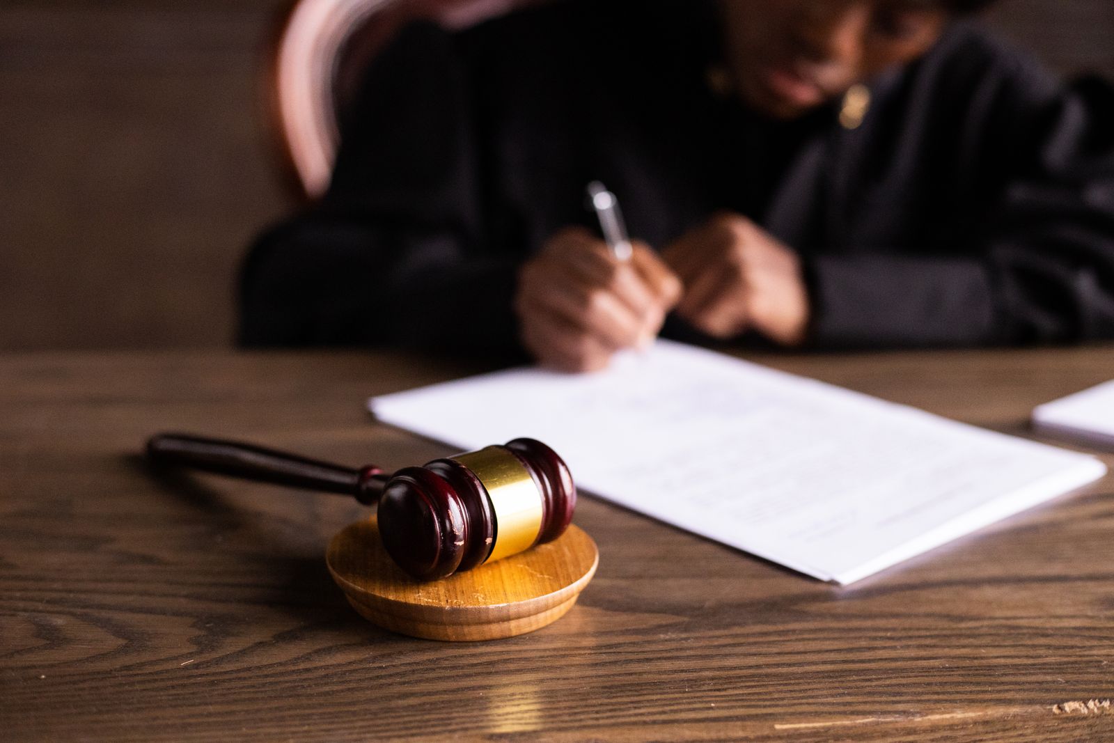 A person reviewing and signing legal papers at a desk